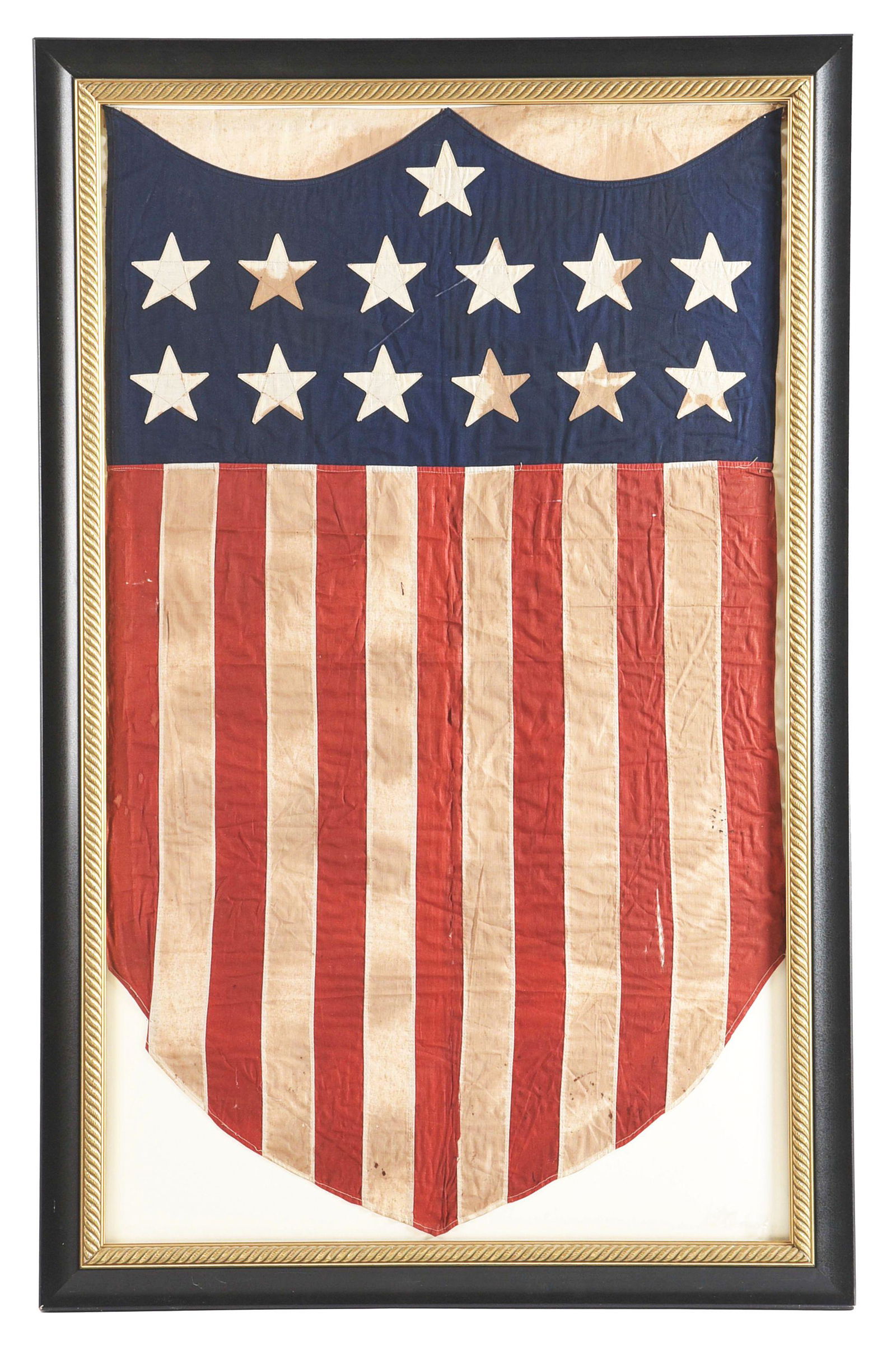 CENTENNIAL 13 STAR SHIELD BANNER.: c. 1876. Cotton and silk with 13 stars and stripes. CONDITION: Staining and losses. KK This is not a standard shippable item and will require 3rd party shipping or pickup arrangements to be made. Cond