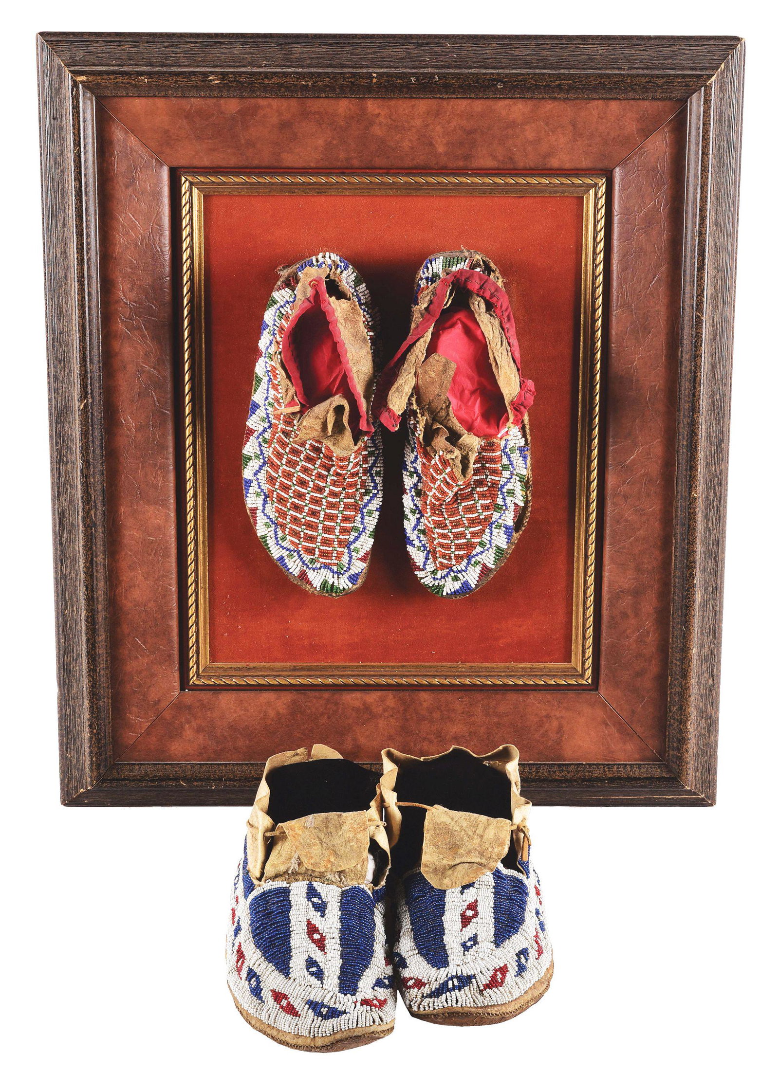 LOT OF 2: PAIRS OF PLAINS BEADED MOCCASINS.: (A) Overall 10-1/2" long and 4" wide. Circa 1880. Classic buffalo track design in blue with white background. Uppers are made of brain tanned hide and are sinew sewn. There are a few tears to the uppe
