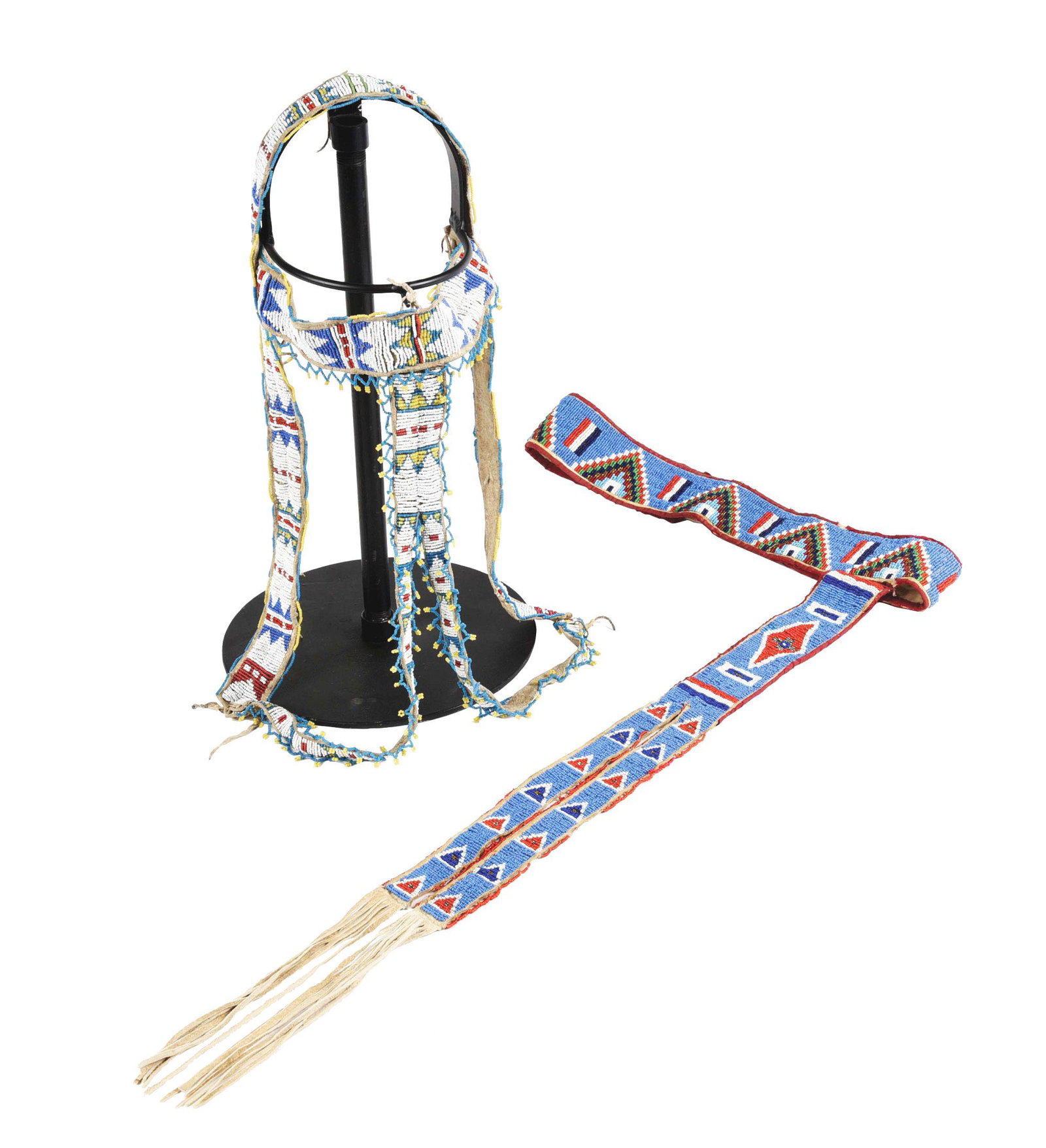 LOT OF 2: BEADED HEADSTALL AND BEADED BELT.: Circa first quarter of the 20th century. (A) Belt measures 29-1/2". Drop measures 29-1/2" including fringe. Missing some bead work. Fabric edges are worn. CONDITION: Good. (B) Headstall has very minim