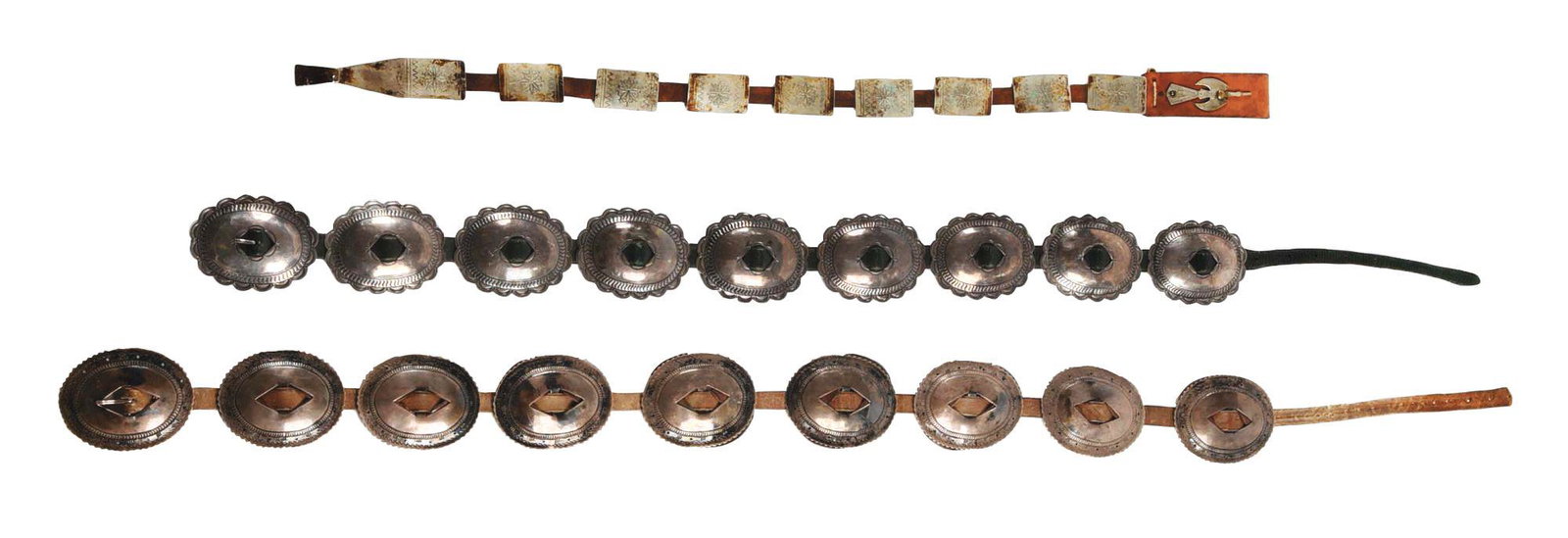LOT OF 3: 2 CONCHO BELTS AND 1 CONCHO DROP.: Lot consists of (A) Nine Navajo silver conchos, eight are leather backed, on a brown leather belt. Conchos have a geometric design around the outer scalloped rim. Buckle has indistinguishable marking 