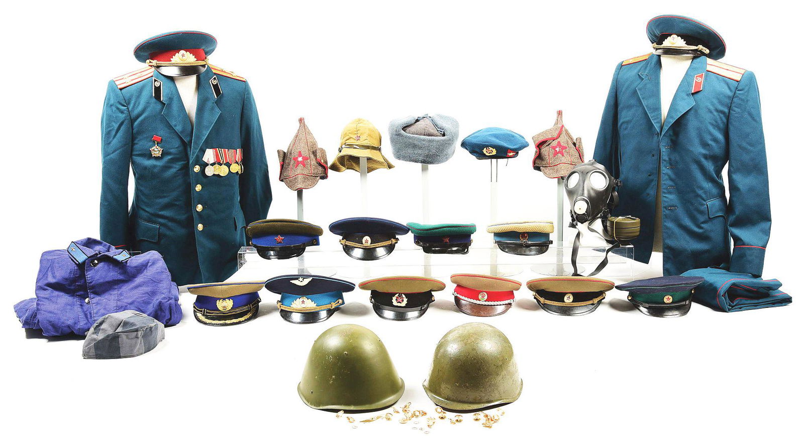 VERY LARGE LOT OF COLD WAR SOVIET AND COMMUNIST: Large Lot of 17 Cold War Era Soviet Caps and Visors, 2 Soviet Russian Officer Uniforms, 1 Pair of Soviet Russian Officer Trousers, 2 Soviet Helmets, 1 Soviet Russian Flight Suit, and 1 Middle Eastern
