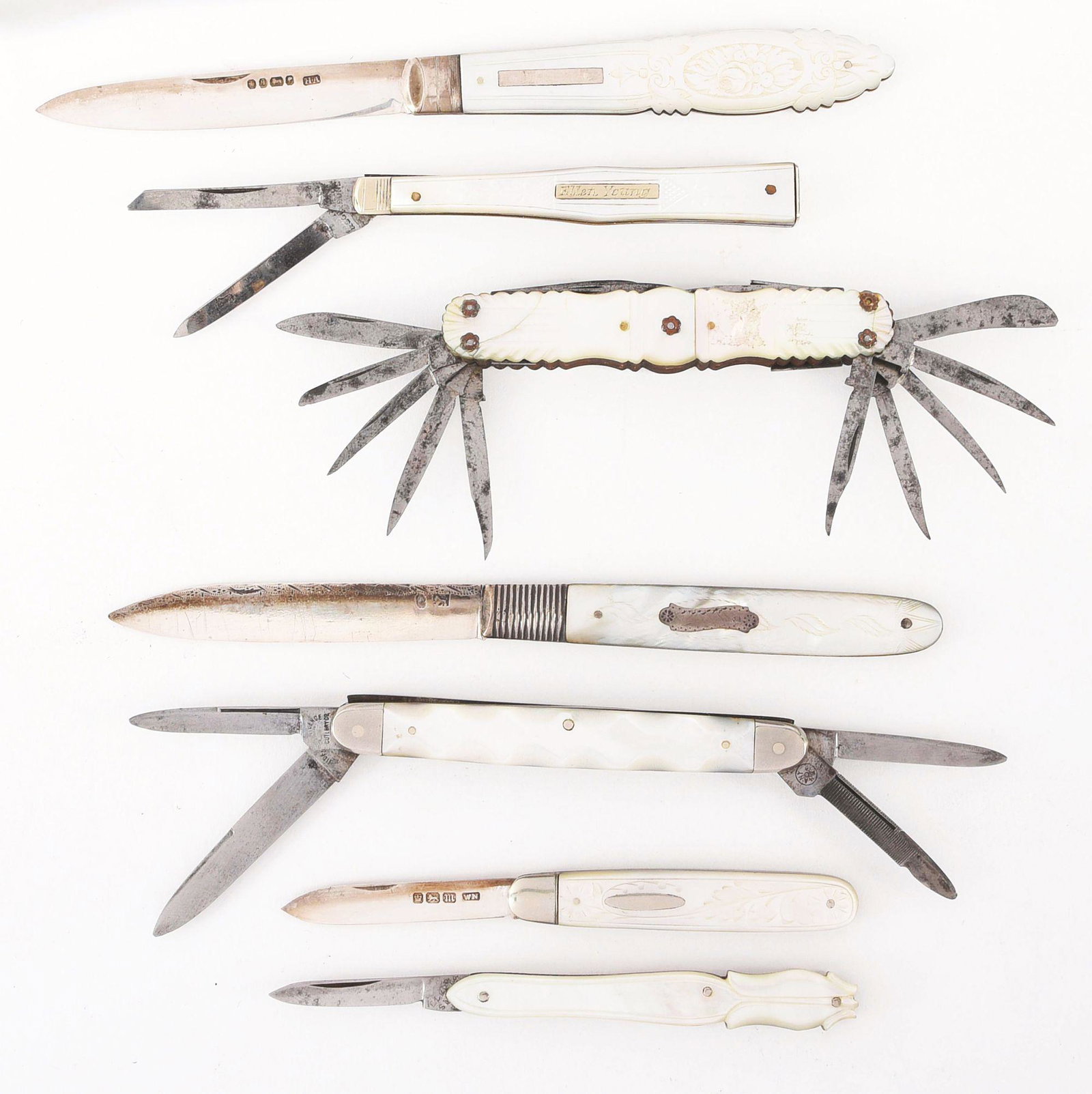 LOT OF 7: FANCY EARLY CARVED AND DECORATED M.O.P.: Lot consists of: A) Early 3 - 1/2" hallmarked fruit knife handled in mother of pearl, beautifully carved. Knife has worked back spring. Knife blade has great snap in both open and closed direction, pe