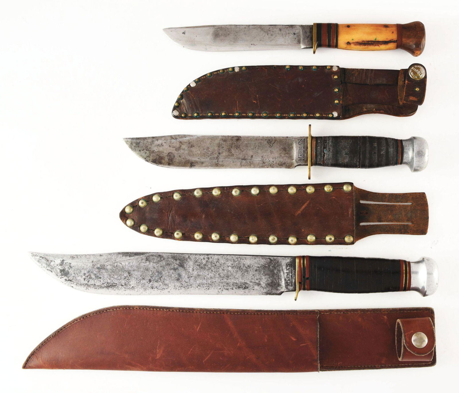 LOT OF 3: MARBLES KNIVES.: (A) Early MARBLES M.S.A. CO. GLADSTONE MICH. USA fixed blade ideal with 5-3/4" blade, full blade fullers. Overall length is 10" handled in genuine stag with early wide red and black spacers, knife has