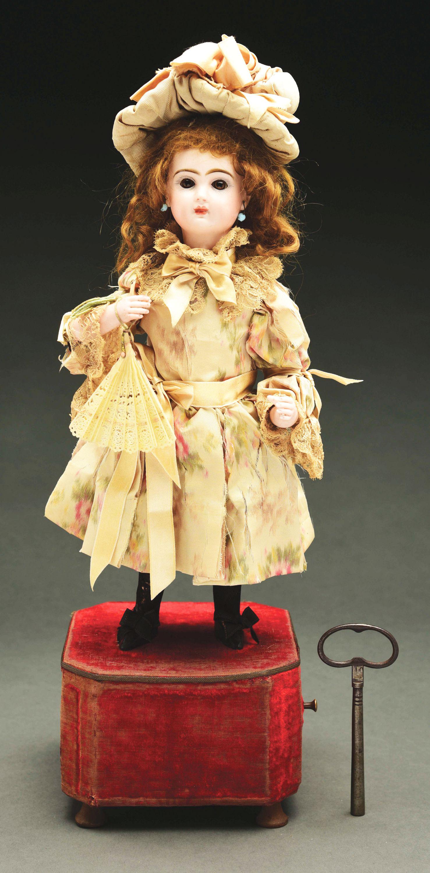 FRENCH BISQUE DOLL AUTOMATON ON RED VELVET BASE. (1 of 3)