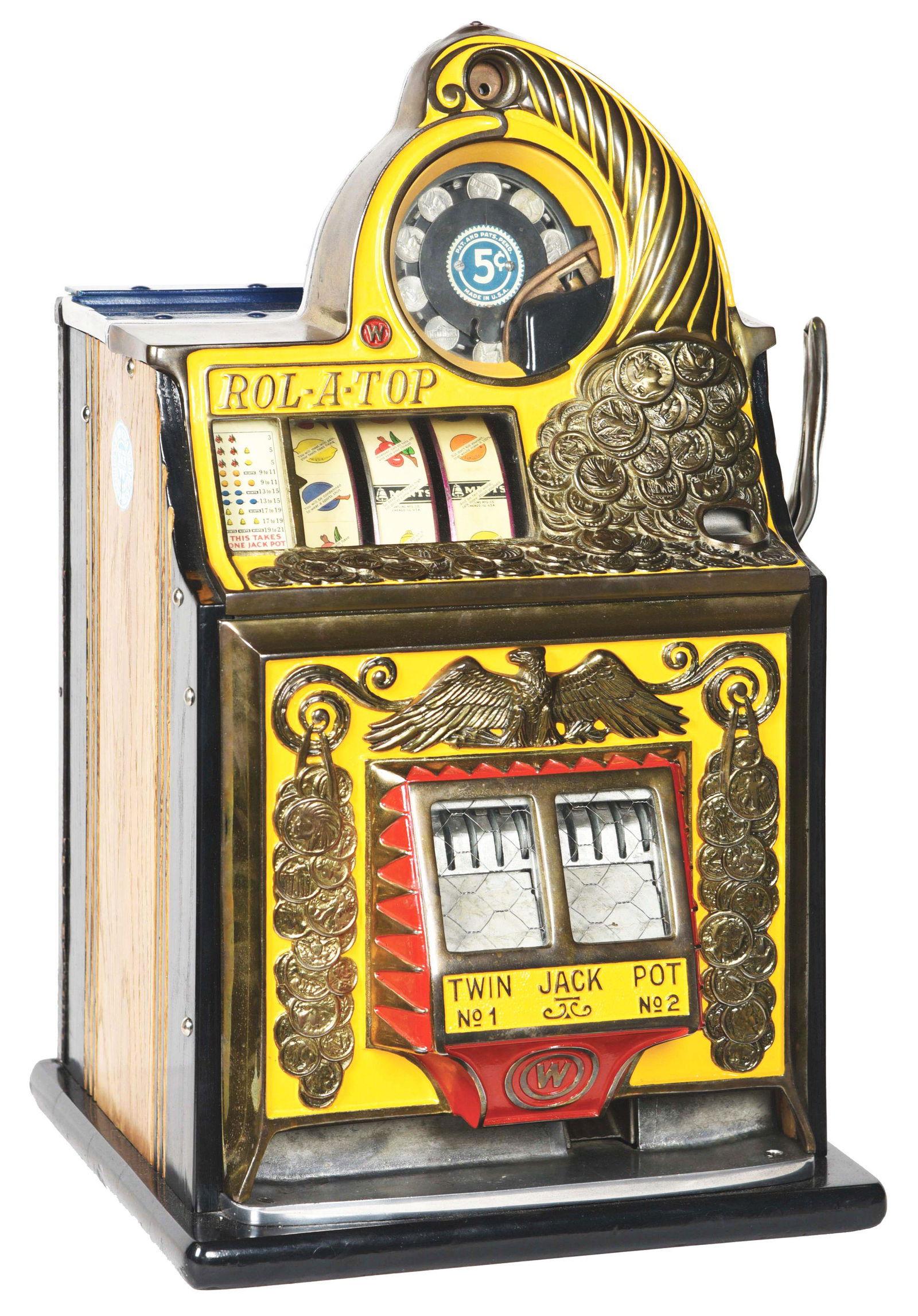 5¢ WATLING COIN FRONT ROL-A-TOP SLOT MACHINE.: This three-reel slot machine is yellow in color and features an upturned cornucopia spilling golden coins over the top and front of the machine. With twin jackpot banks proudly displayed front and cen