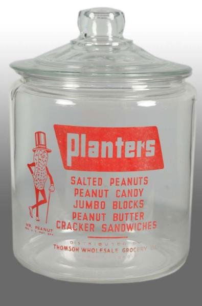 Glass Planters Peanut Mr. Peanut Round Jar.: Description 1940s. Distributed by Thomson Wholesale Grocery Company. Display jar is unusual as the jar contains five product line descriptions done in red lettering with no white frosted background. N