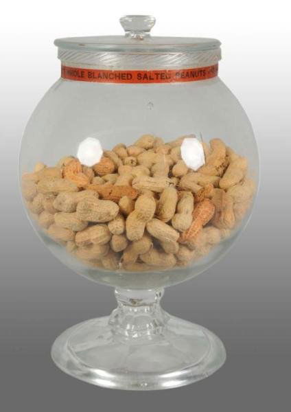 Glass Planters Peanut Mr. Peanut Pedestal Jar.: Description 1920s. This display jar is the first jar produced for Planters. The jar has the original orange paper band label that goes around the rim of the jar, which states "Planters Pennant Whole B