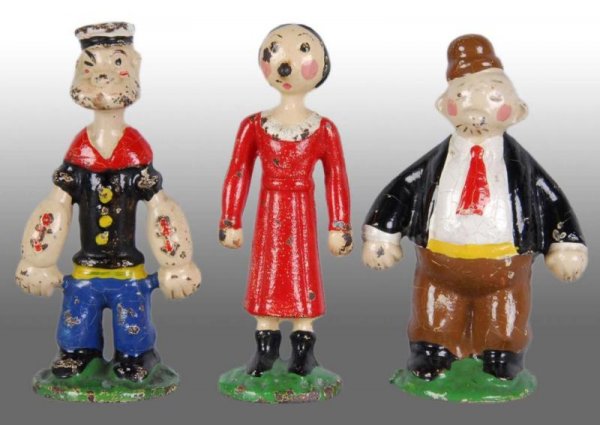Set of 3 Cast Iron Popeye Paperweights.: Description American. Marked "King Features Syndicate 1928" on back of figures. Some moderate paint chipping and wear with some crazing to Wimpy and Popeye. Figural Cast Iron Condition (Very Good). Si
