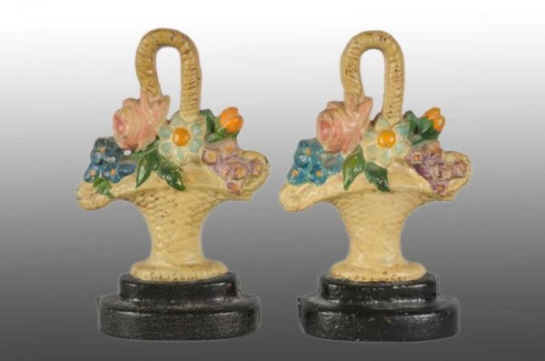 Lot of 2: Cast Iron Flowers in Basket Doorstops.: Description Made by Hubley, cat. #9. Painted matching pair of door stops that could be used as bookends. Figural Cast Iron Condition (Excellent). Size 8 - 1/4" x 5 - 1/4".