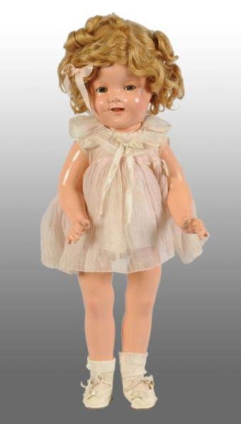 Ideal Composition Shirley Temple Doll: Description American, circa 1930s. Marked Shirley Temple 18 on head and body. Clear sleeping eyes with eyelashes and mussed original wig. Beautiful composition with several craze lines on face and chi
