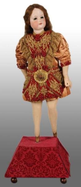 Armand Marseille Automaton Doll.: Description Bisque head with composition extremities. Doll stands on 11-inch tall base and turns as foot and arm raise up. Possibly a window display. Condition (Excellent). Size Doll: 40" T.