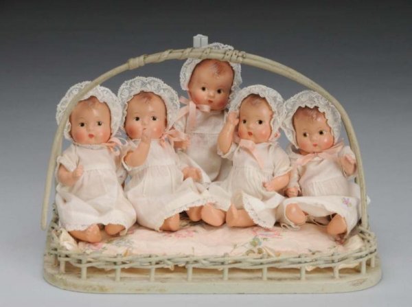Effanbee Comp Baby Tinyette Quintuplet Dolls: Description American, circa 1930s. Five all-composition dolls fully marked with jointed necks, shoulders and hips. They have molded brown hair, painted brown eyes, closed mouths and rosy cheeks. Weari