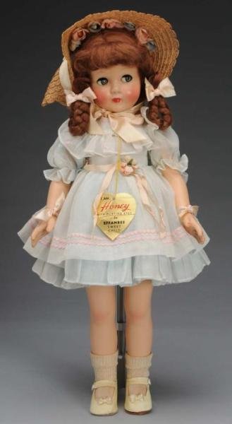 Effanbee Composition Honey Doll: Description American, circa 1940s. Embossed Effanbee on torso, composition head with lashed blue flirty eyes, closed mouth, brown mohair wig with braids, original blue organdy dress, undergarments, st