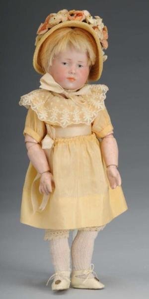 Kammer & Reinhardt Character Child Doll.: Description German, circa 1910. Bisque socket head incised K [star] R 101. Painted features, replaced mohair wig. Original fully jointed K & R composition body. Wearing yellow silk dress, straw hat, u
