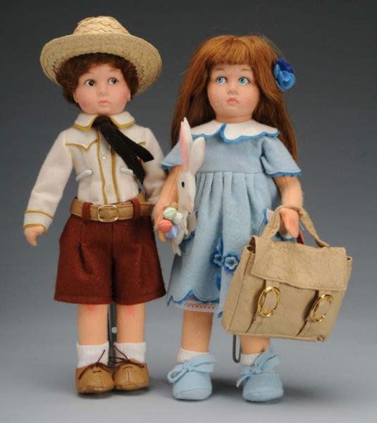 Lot of 2: Felt Lenci Girl & Boy Dolls.: Description Italian, circa 1990s. Jointed felt dolls with molded heads. Lovely faces with painted side-glancing eyes and closed mouths with lip shading. Wearing original costume and each carrying an a