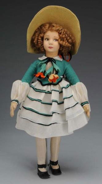 Rare and Desirable Felt Lenci Girl Doll: Description Italian, circa 1926. Jointed 400 Series felt doll with molded head. Lovely face with brown painted side-glancing eyes, curly light brown mohair wig, and closed mouth with lip shading. Wear