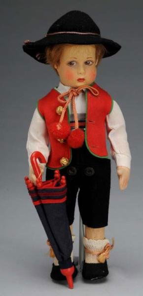 Felt Lenci Boy Doll w Label and Umbrella.: Description Italian, circa 1930s. Jointed felt doll with molded head and lovely colorful face. Brown painted side-glancing eyes with lovely lashes, light brown mohair wig, and closed mouth. Original o