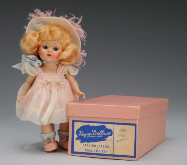 Vogue Hard Plastic Ginny Angela #65 Doll: Description American, circa 1950s. All hard plastic strung doll, blonde mohair wig, blue sleep eyes, rosy cheeks, original pink and white dress with smocking, matching panties, white felt hat, shoes a