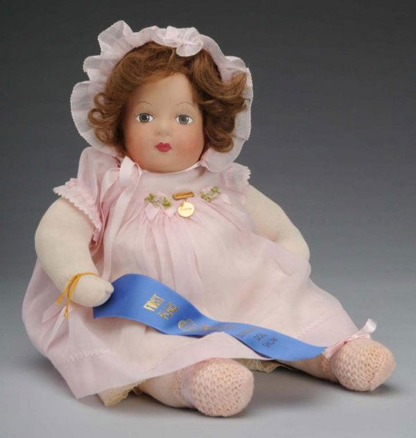 Madame Alexander Dionne Quintuplet Emelie Doll: American, 1930s. Rare. Mask face with brown painted eyes, brown human hair wig, chubby stockinette body, Alexander gold Emelie name pin, pink cotton dress and matching hat, slip, and booties. Face rep