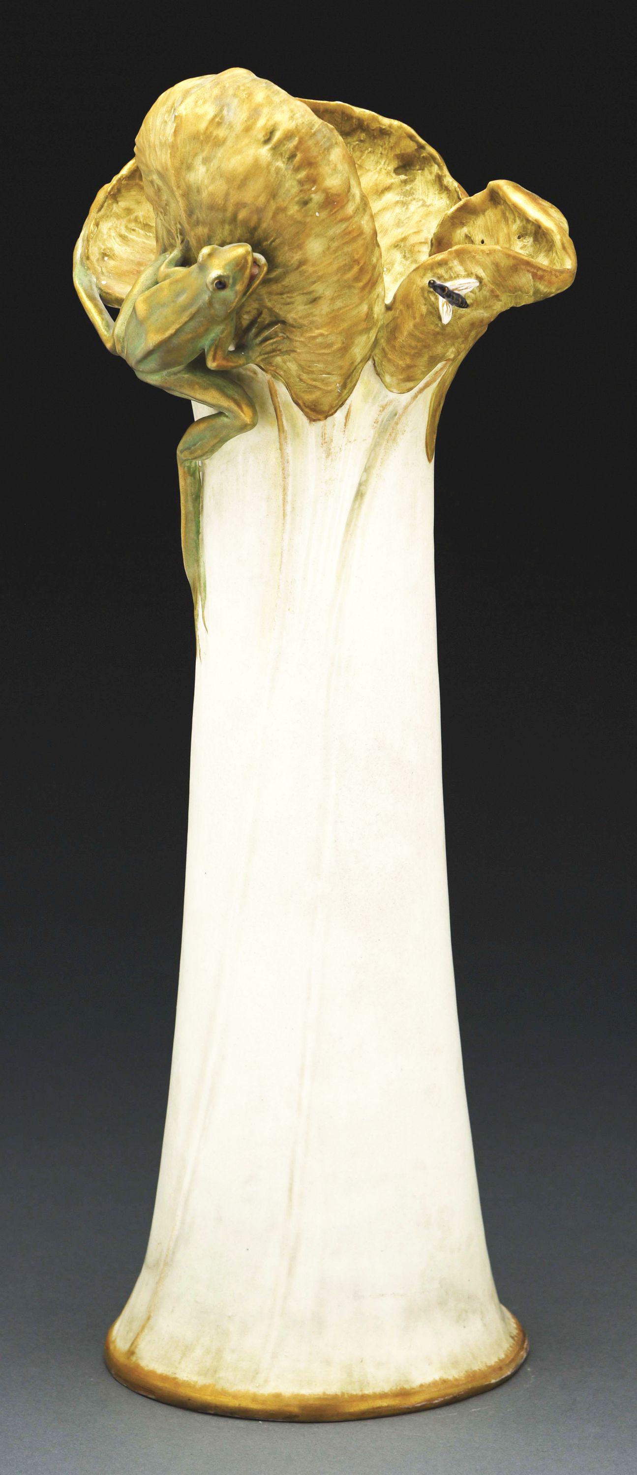 EDUARD STELLMACHER FROG AND WATER LILY VASE.: Cream, gold and green glazes with applied frog and insect. Signed on body of the vase "Ed Stellmacher". Stellmacher raised monogram, Stellmacher mark. 21 - 3/4" high. Illustrated in Monsters and Maide