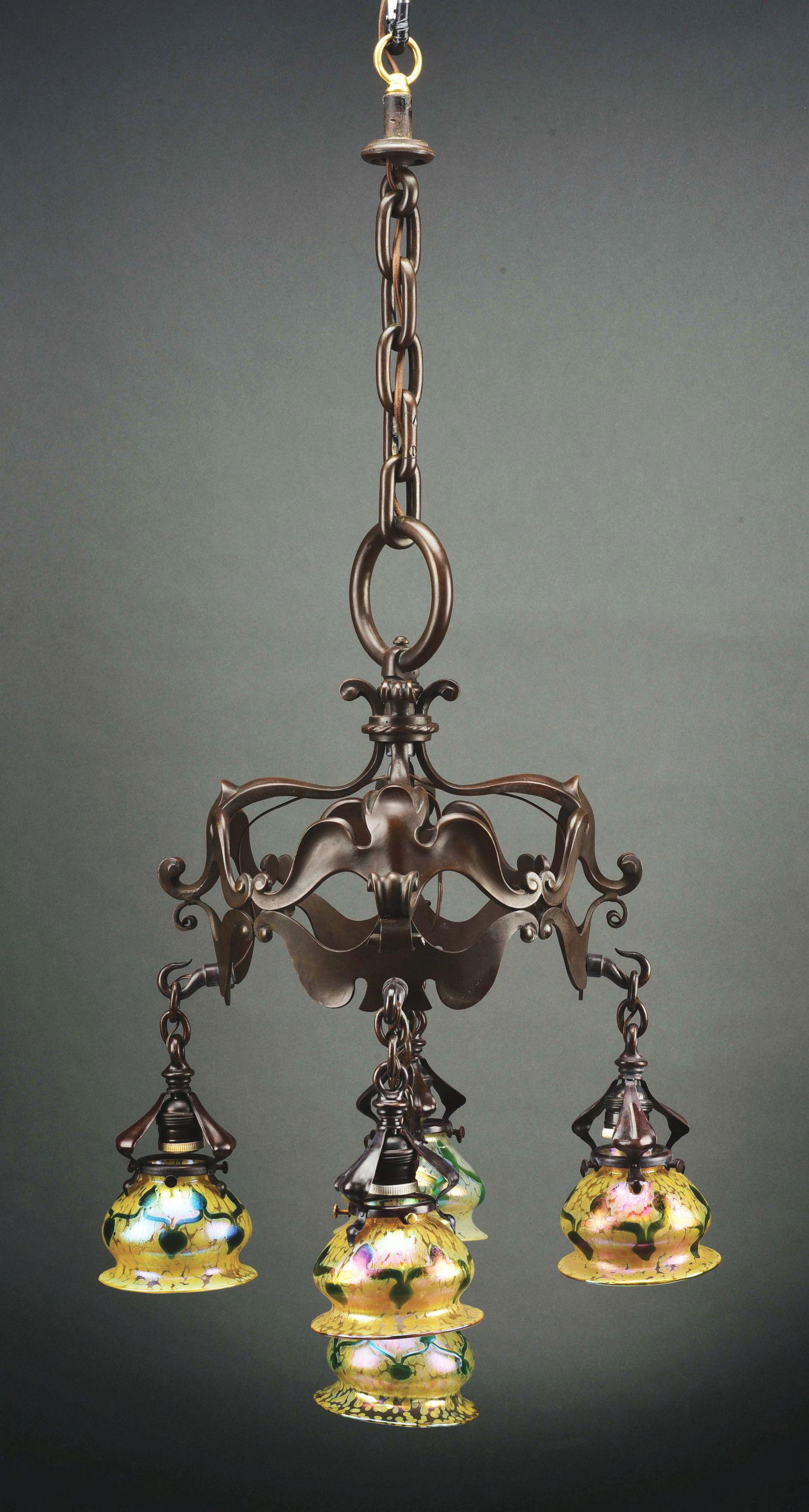 LOETZ CHANDELIER WITH FIVE SHADES.: An Art Nouveau patinated bronze and glass chandelier decorated with five matching Austrian art glass Loetz shades decorated with iridescent green leaf and vine decoration against an iridescent oil spo