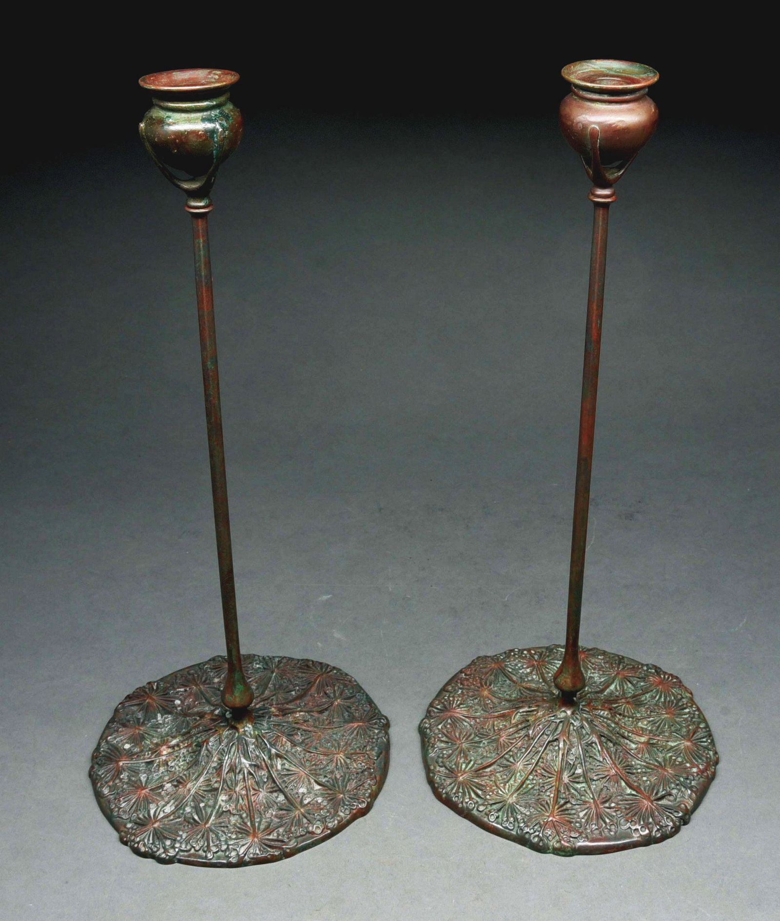 QUEEN ANNE'S LACE CANDESTICKS.: A pair of Tiffany Studios patinated bronze Queen Anne's Lace candlesticks with cast standard decorated candle cups graduating into a stem further decorated with a Queen Anne's Lace cast bronze decorat