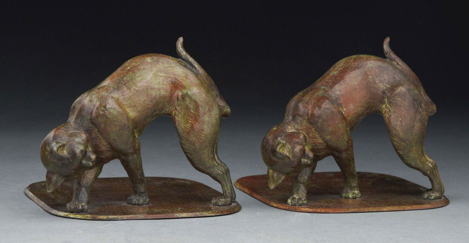 CAT BOOKENDS.: Tiffany Studios bronze cat bookends finished in a brown-green patina and further signed "Tiffany Studios New York". c. 1900. Condition: (Excellent). Dimensions: Each: 6 - 1/2" x 7 - 1/2" x 7 - 1/2".