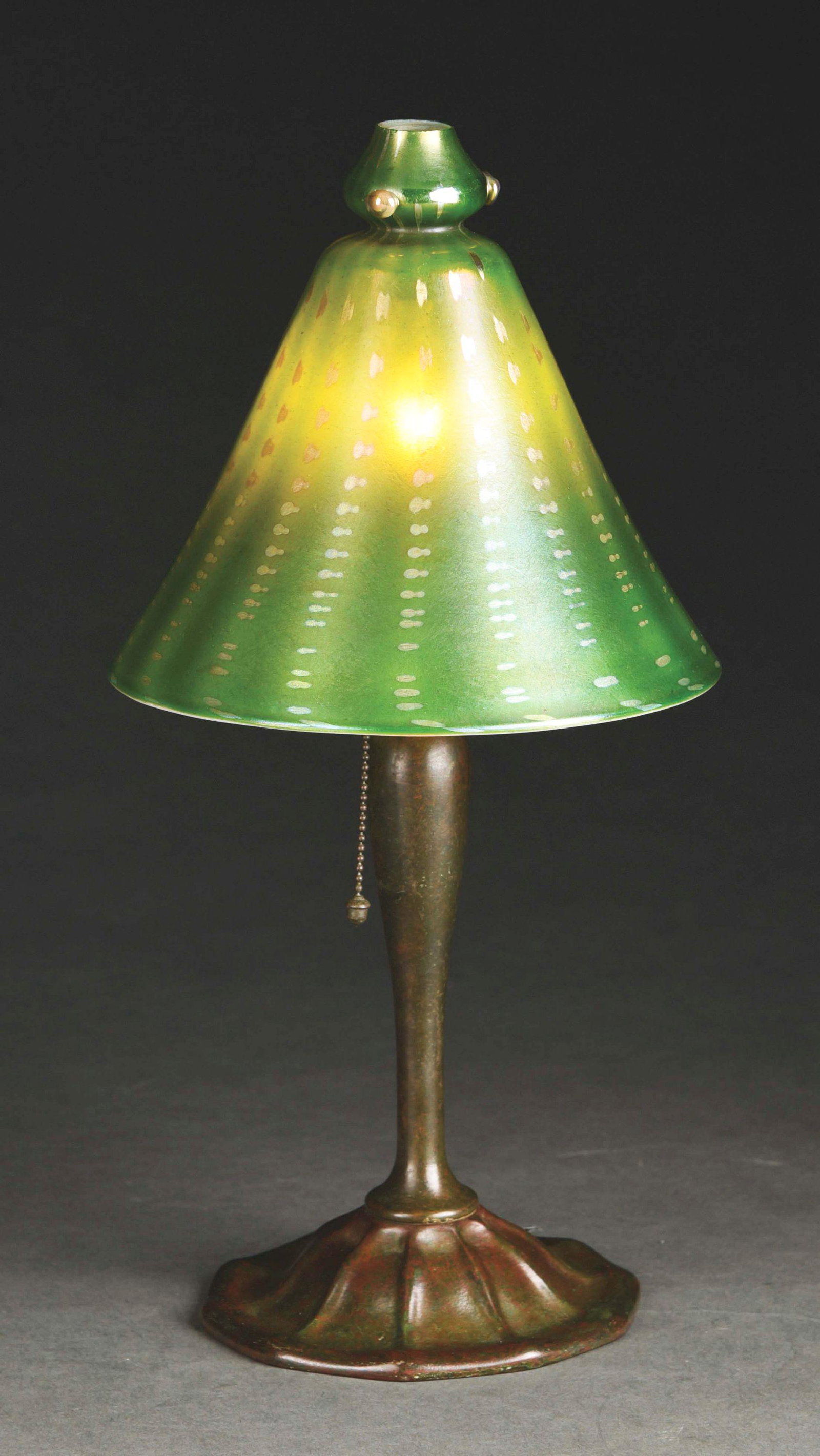 TIFFANY STUDIOS ARABIAN BOUDOIR LAMP.: A lovely favrile glass Arabian style boudoir lamp by Tiffany Studios. The conical shade features three gold jewels at the crest, and a simple vertical pattern set against an iridescent green backgroun