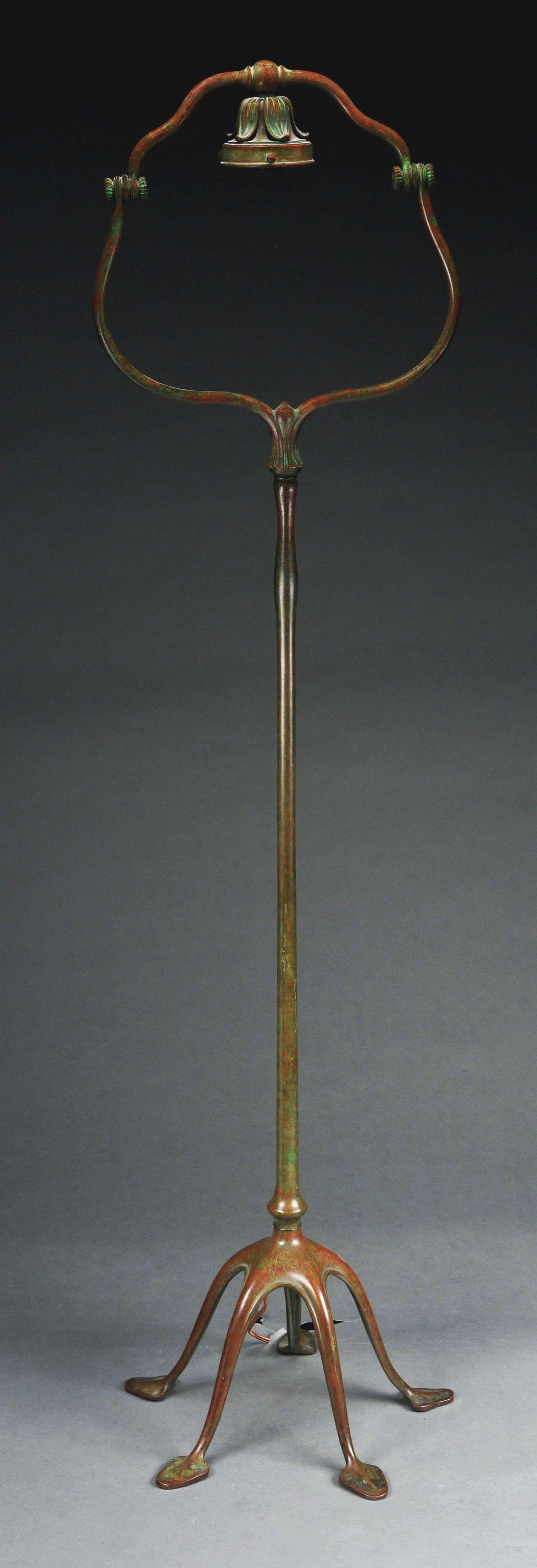 FIVE-LEGGED TIFFANY HARP FLOOR LAMP BASE.: Tiffany Studios patinated cast bronze five-legged standing harp floor lamp base by Tiffany Studios, decorated with five spade feet and has an adjustable harp that accommodates a 3 - 1/4" fitter shade 