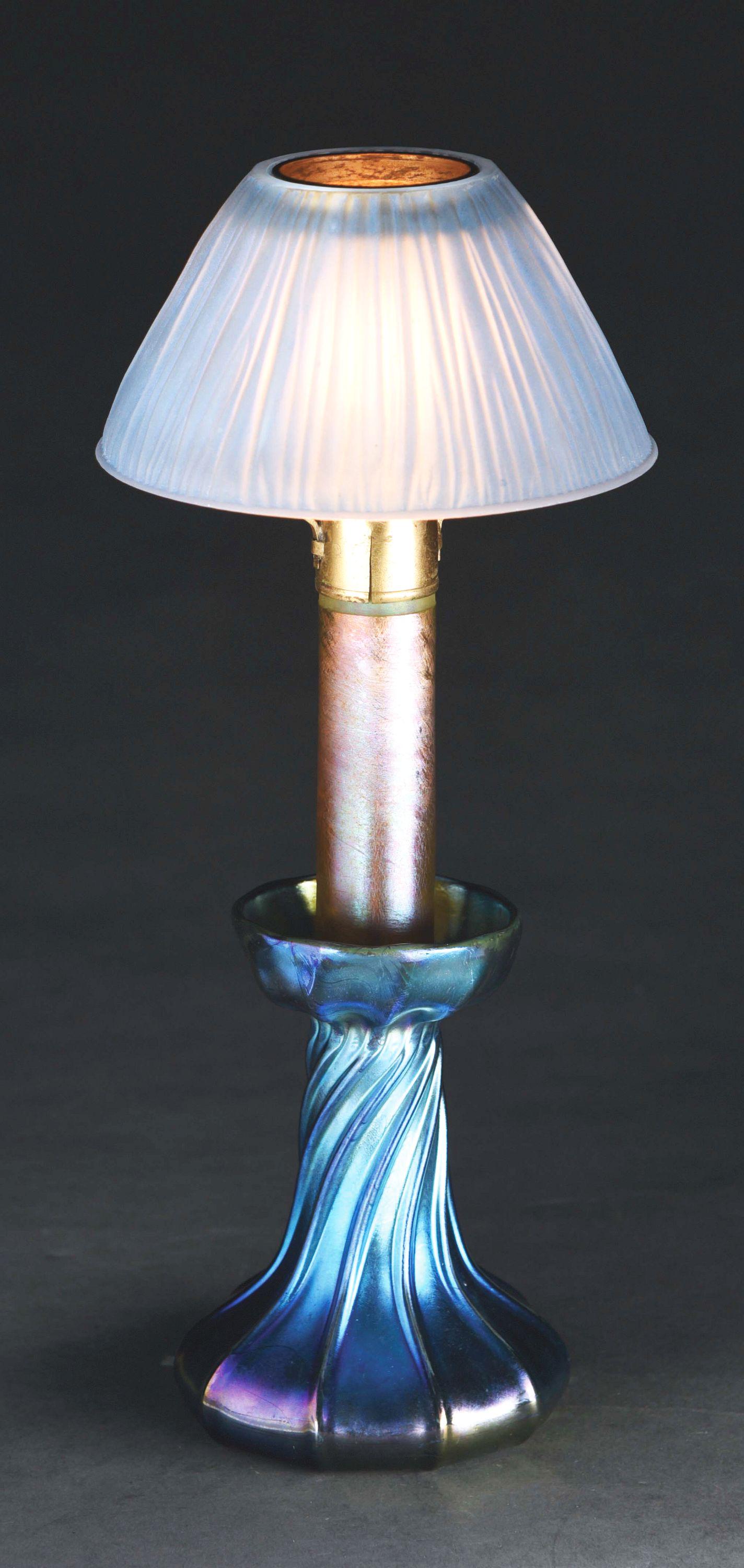TIFFANY STUDIOS CANDLESTICK LAMP WITH LINENFOLD SHADE.: A beautiful blue Tiffany Studios linenfold shade on an iridescent candlestick base. The shade is composed of a soft baby blue Favrile glass in a tight linenfold pattern. It is 5 - 3/8” in diameter a