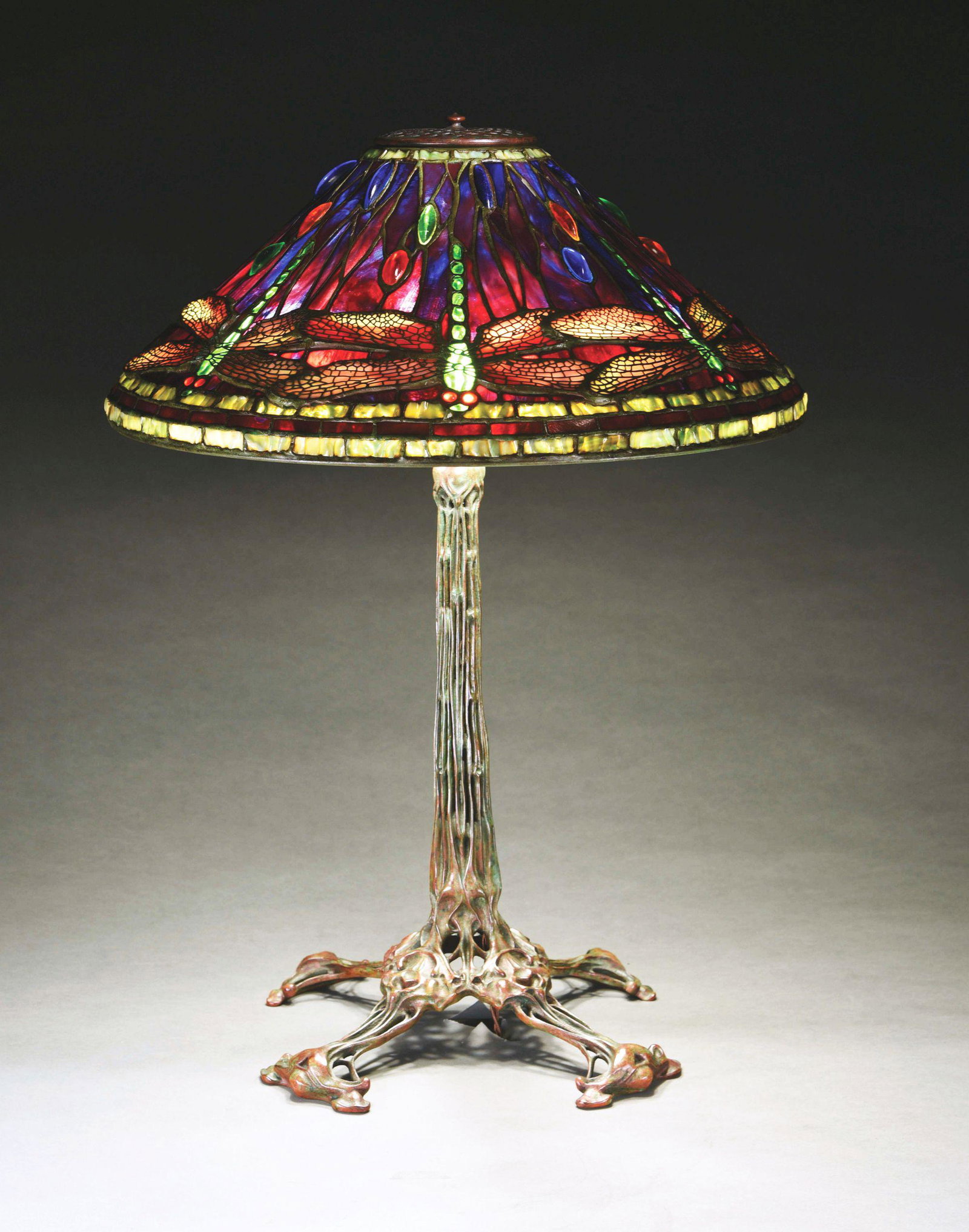 AMERICAN REPRODUCTION OF TIFFANY STUDIOS DRAGONFLY: An extremely high quality reproduction of a Tiffany Studios dragonfly lamp on a bronze bird skeleton base. The shade is a 20” diameter leaded glass shade that features the iconic dragonfly pattern l