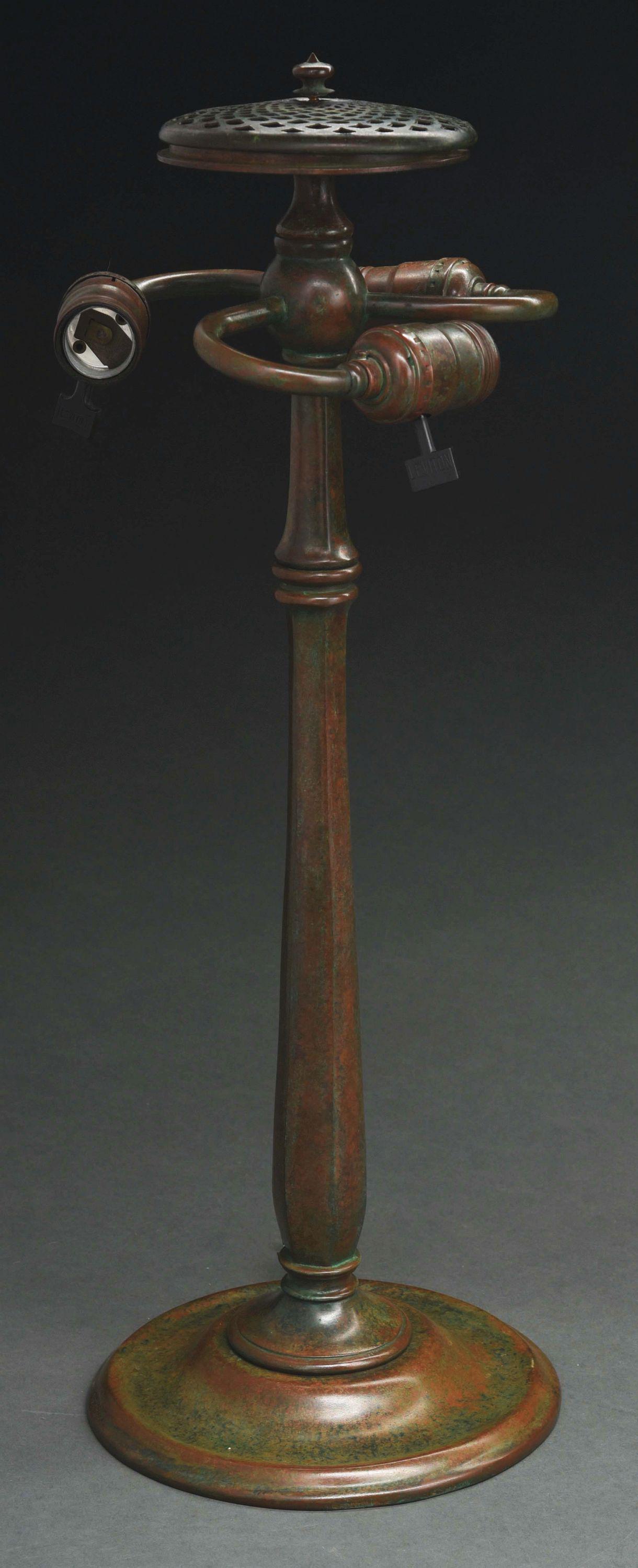 REPRODUCTION OF TIFFANY STUDIOS COLONIAL LAMP BASE.: An extremely high quality reproduction of a Tiffany Studios colonial lamp base. The bronze base is finished in a reddish-brown patina with green highlights. It has a three-socket cluster and stands 20