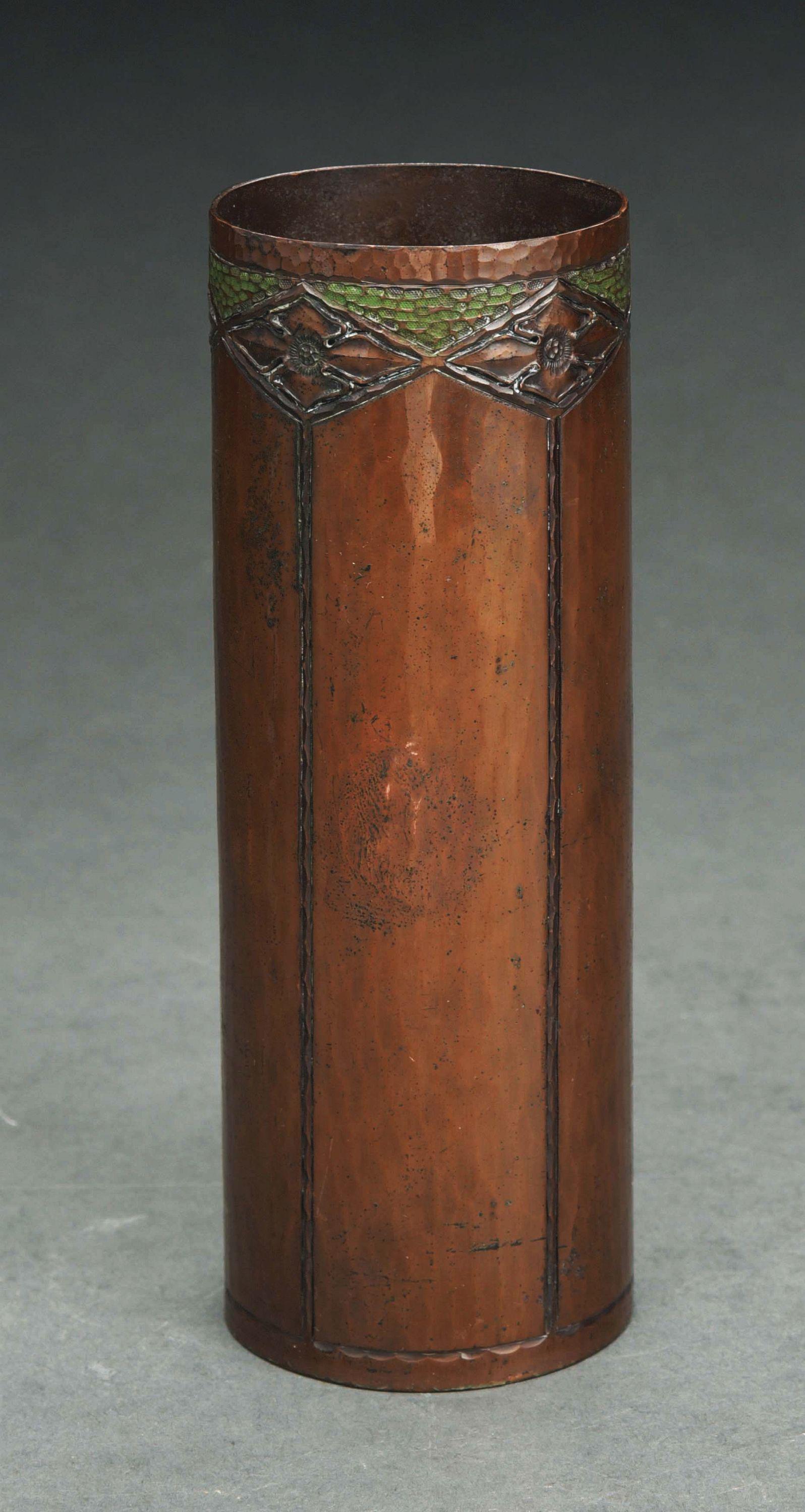 ROYCROFT HAMMERED COPPER CYLINDRICAL VASE.: Copper vase with tooled quatrefoils. 7" high. Attributed to Roycroft artisan Walter Jennings according to the Roycroft mark with two dots inside the orb, a mark used by Jennings between 1916 - 1920. P
