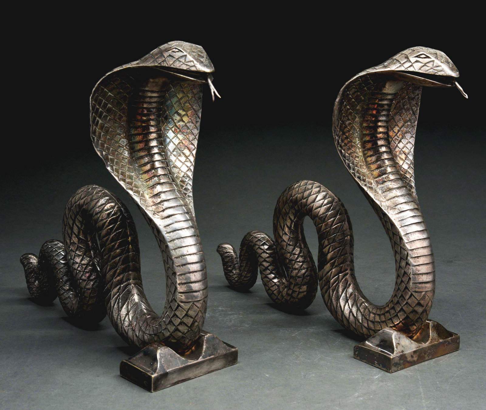 PAIR OF COBRA ANDIRONS.: Silvered bronze. Stamped by maker: E BRANDT for Edgar Brandt (France, 1880-1960), circa 1925. Minor wear. Condition: (Very Good). Dimensions: Each: 11 - 1/2" x 13 - 1/2" x 4".
