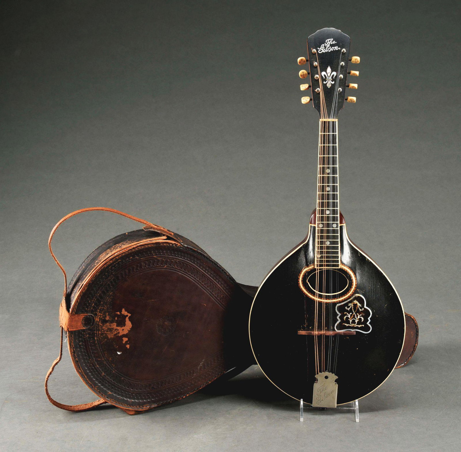 GIBSON MANDOLIN GUITAR.: Comes with original paper label and case. Mother of pearl inlay. Model No. 4868. Separation from bottom to top of body. Condition: (Very Good - Excellent). Dimensions: 27" x 12" x 4".