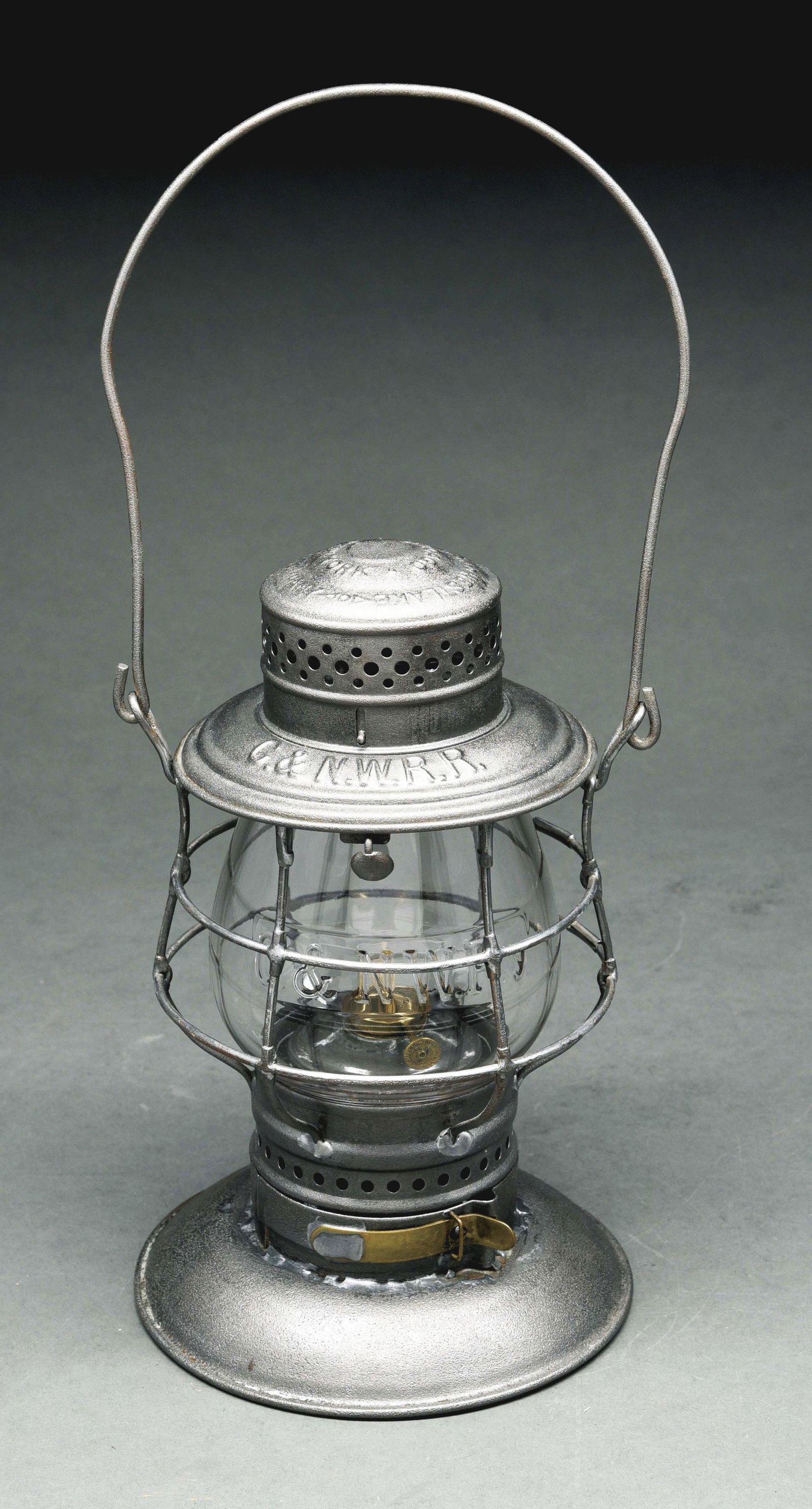 C.& N. W. R. R. ADAMS & WESTLAKE DOUBLE GUARD: A common A&W frame style with a removable top globe holder. The frame is straight and tight. The bayonet base fits snugly and is one of a few different A&W styles found on this model. It is equipped w