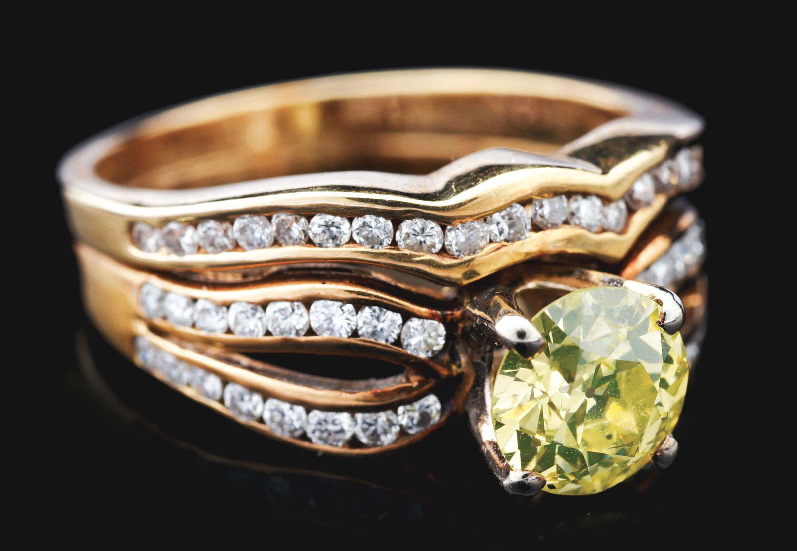 14K GOLD DIAMOND BRIDAL SET W/FANCY YELLOW 1.10CT ROUND: Lady's 14K yellow gold diamond bridal set with yellow diamond center, consisting of 1 round brilliant cut fancy yellow to greenish-yellow diamond measuring approximately 6.8x6.8x3.95mm with an estimat