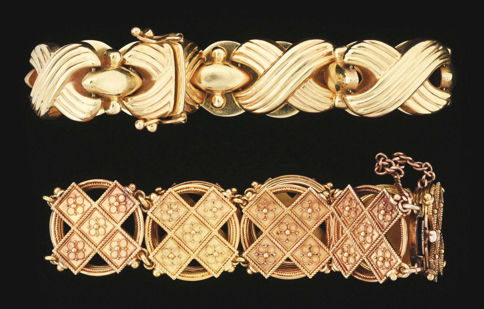 LOT OF 2: 14K YELLOW GOLD "X&O" ESTATE JEWELRY: Lot of 2: 14K yellow gold "X&O" style estate jewelry bracelets. Both with integrated hidden box clasps. One has double safety locks, and the other has a fixed safety chain. The heavier bracelet is han