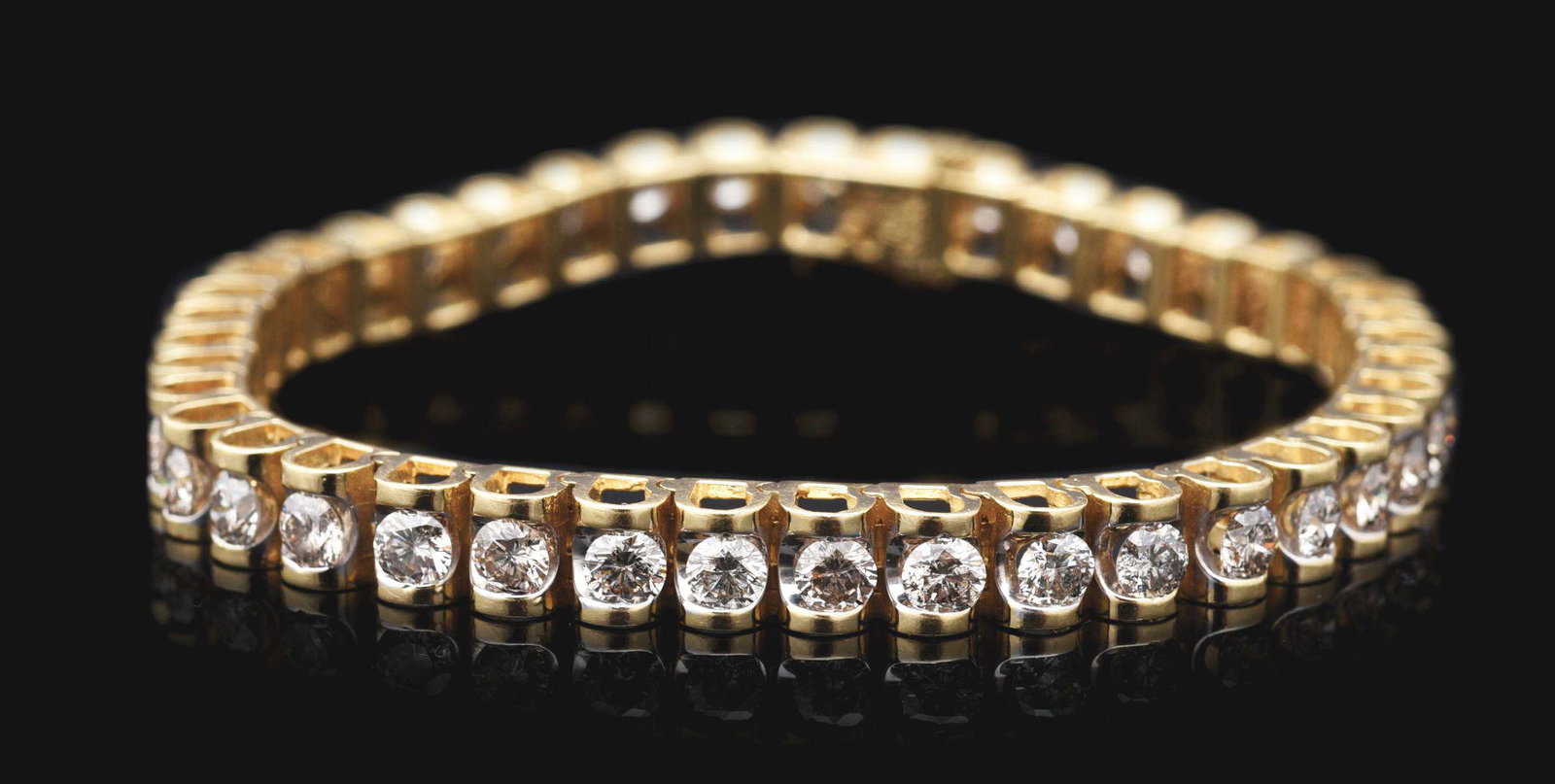 14K YELLOW GOLD 7CT DIAMOND TENNIS BRACELET.: Lady's 14K yellow gold diamond tennis bracelet consisting of 41 channel-set round brilliant cut diamonds measuring approximately 3.6mm each, with an estimated total weight of 7.00cts. Stones appear to