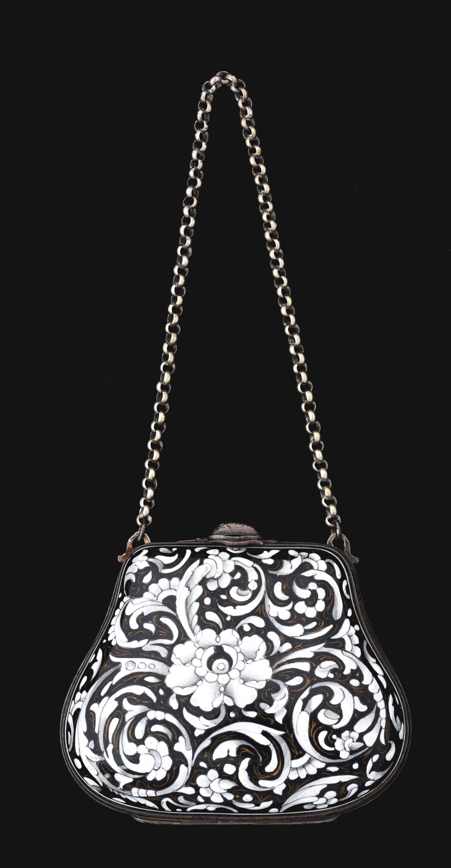 SILVER COMPACT PURSE.: Silver compact purse with enamel embossed flowers opens to reveal silk-lined compartments. No enamel loss. Has chain. Condition: (Excellent). Dimensions: