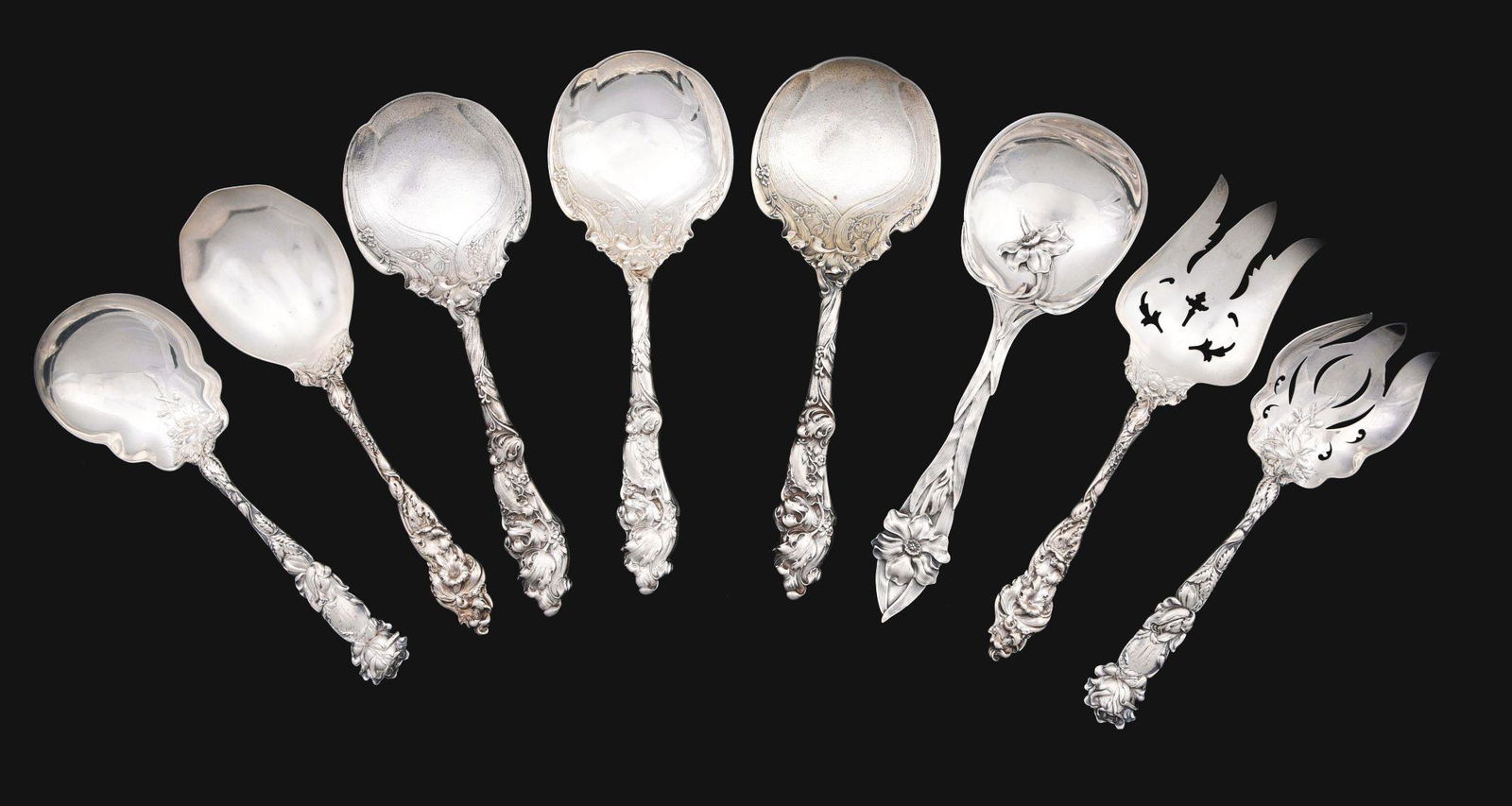 A GROUP OF AMERICAN STERLING SERVING SPOONS.: Including three Gorham berry spoons, H158 pattern; a serving spoon and fork, Red & Barton Les Six Fleurs pattern; a berry spoon with a large flower on the stem, Towle; and a fork and spoon, Alvin Brid