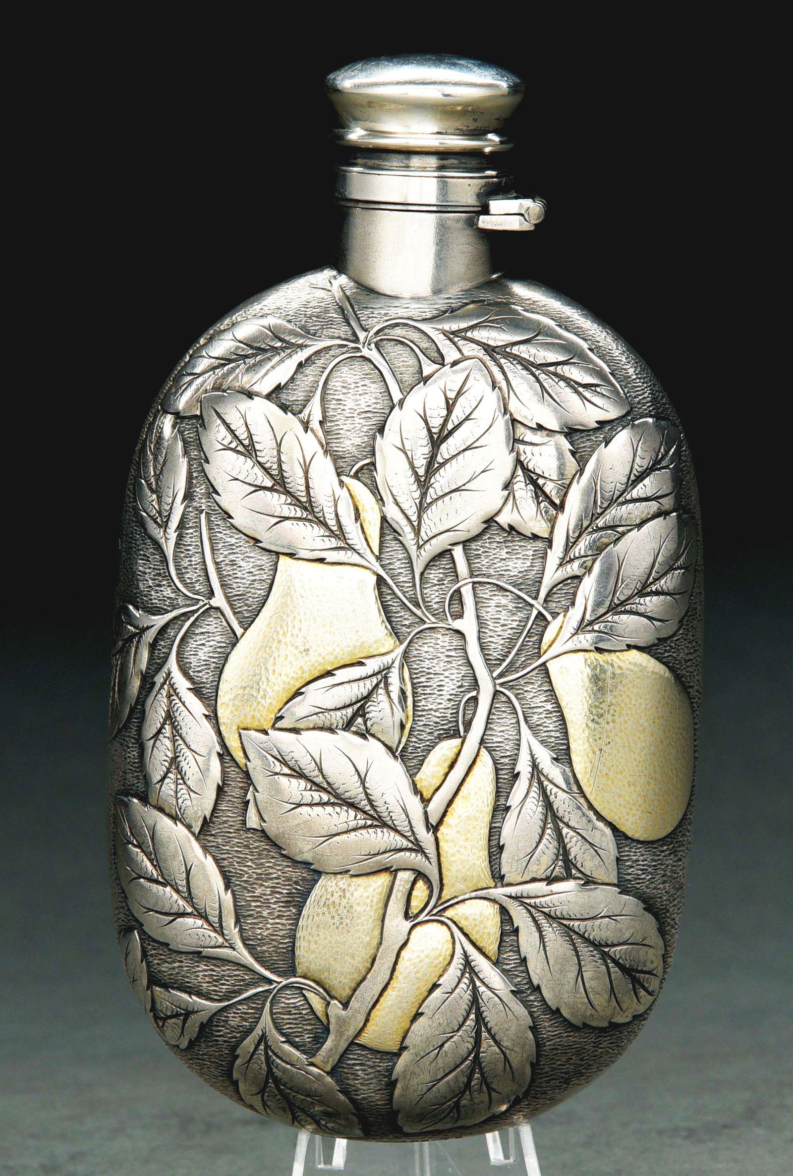 A GORHAM STERLING FLASK.: 1883. The ovoid body chased on the front with three gilt pears and leaves, the reverse engraved with a coat of arms, wreath, and presentation inscription below. Small dents and depressions to body esp