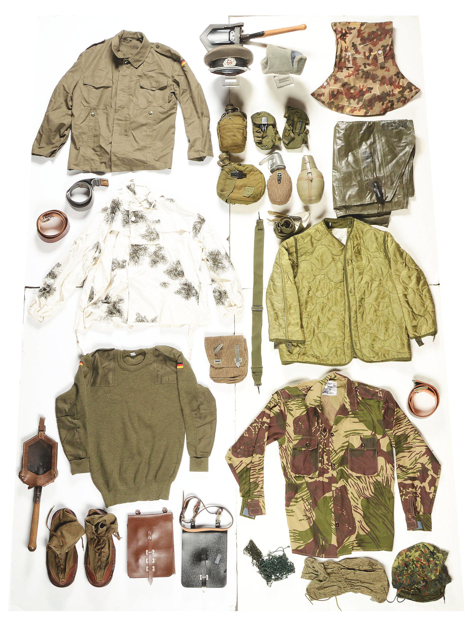 LARGE LOT OF MISCELLANEOUS US, WEST GERMAN, AND EAST: Lot contains 51 pieces of miscellaneous post-World War II US, West German, and East German military items. West German items include field grey shirts and wool trousers, map cases, etc. East German Co