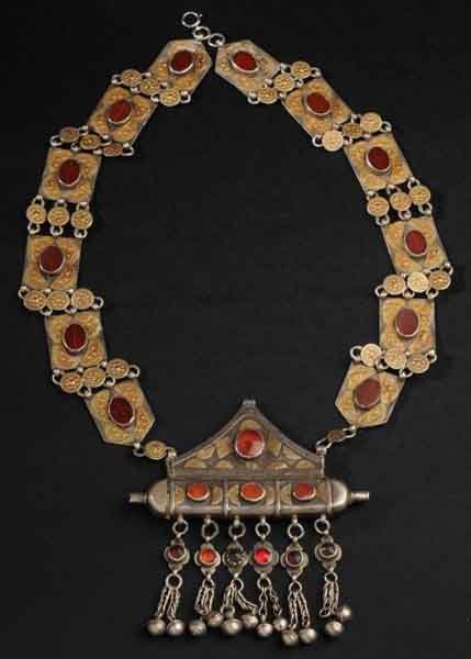 Middle Eastern Red Stone Necklace.: Description No markings. Red polished and other stones that dangle from chain. Lower medallion is 4.25-inches wide with intricate workings and inlay. Condition (Excellent). Size 28" L.