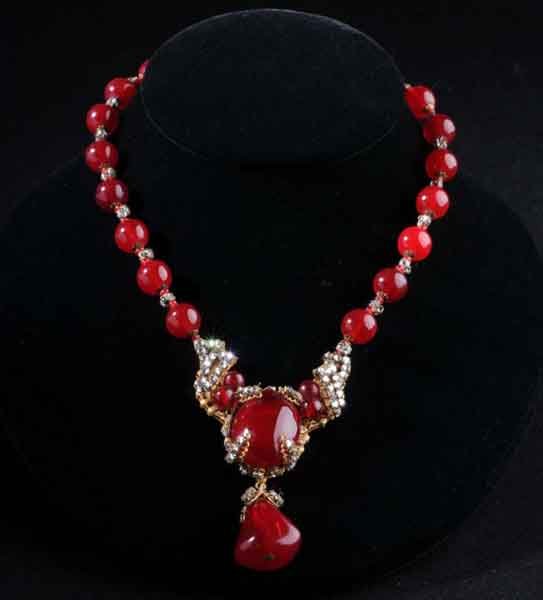 Signed Miriam Haskell Necklace.: Description Red glass pendant with wired, clear rhinestones. One clear rhinestone missing from top of pendant. Condition (Very Good). Size 15" L.