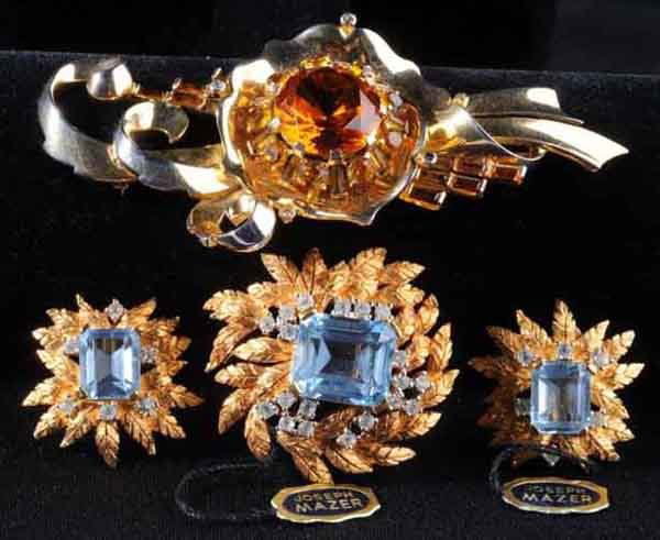 Signed Mazer Pin & Signed Jomaz Pin with Earrings.: Description Mazer gold-tine pin with amber center stone, amber baguettes, and some gold wash loss. Also includes Jomaz pin and earrings with aquamarine center square stone surrounded in clear rhinesto