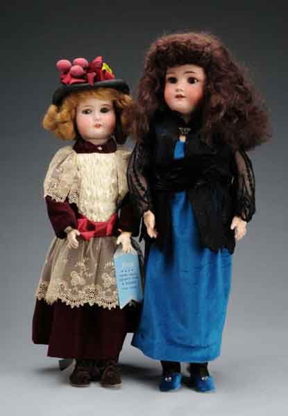 Lot of 2: German Bisque Child Dolls.: Description Largest is a Simon & Halbig Heinrich Handwerck doll with brown glass sleep eyes, open mouth with teeth, and original body with some repaint and appropriately redressed. One slight red firi