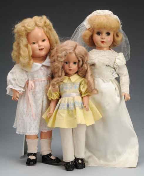 Lot of 3: American Composition Dolls.: Description Largest is an unmarked doll dressed as a bride. Also includes a girl in a yellow dress and an Ideal Shirley Temple doll. Condition (Good). Size Largest: 17" T.