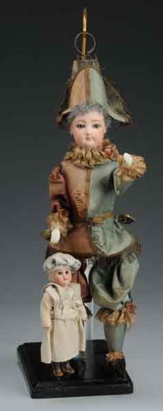 Francois Gaultier Polichinelle Walking Doll.: Description French. Circa 1890. Pressed bisque flange head with blue paperweight glass eyes, finely painted brows and lashes, closed mouth, pierced ears, gray wool wig, jointed arms and legs, and bisq