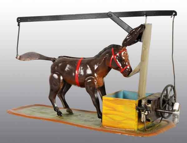 Tin Hand-Painted Donkey Wind-Up Toy.: Description German. Working. When wound, donkey's tail and ears go up and down while feeding out of a trough. Some restoration to the donkey figure and one solder repair to wind-up mechanism. Conditio